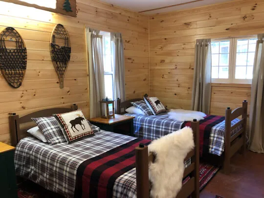 Cabin room with made-up twin beds and fresh linens