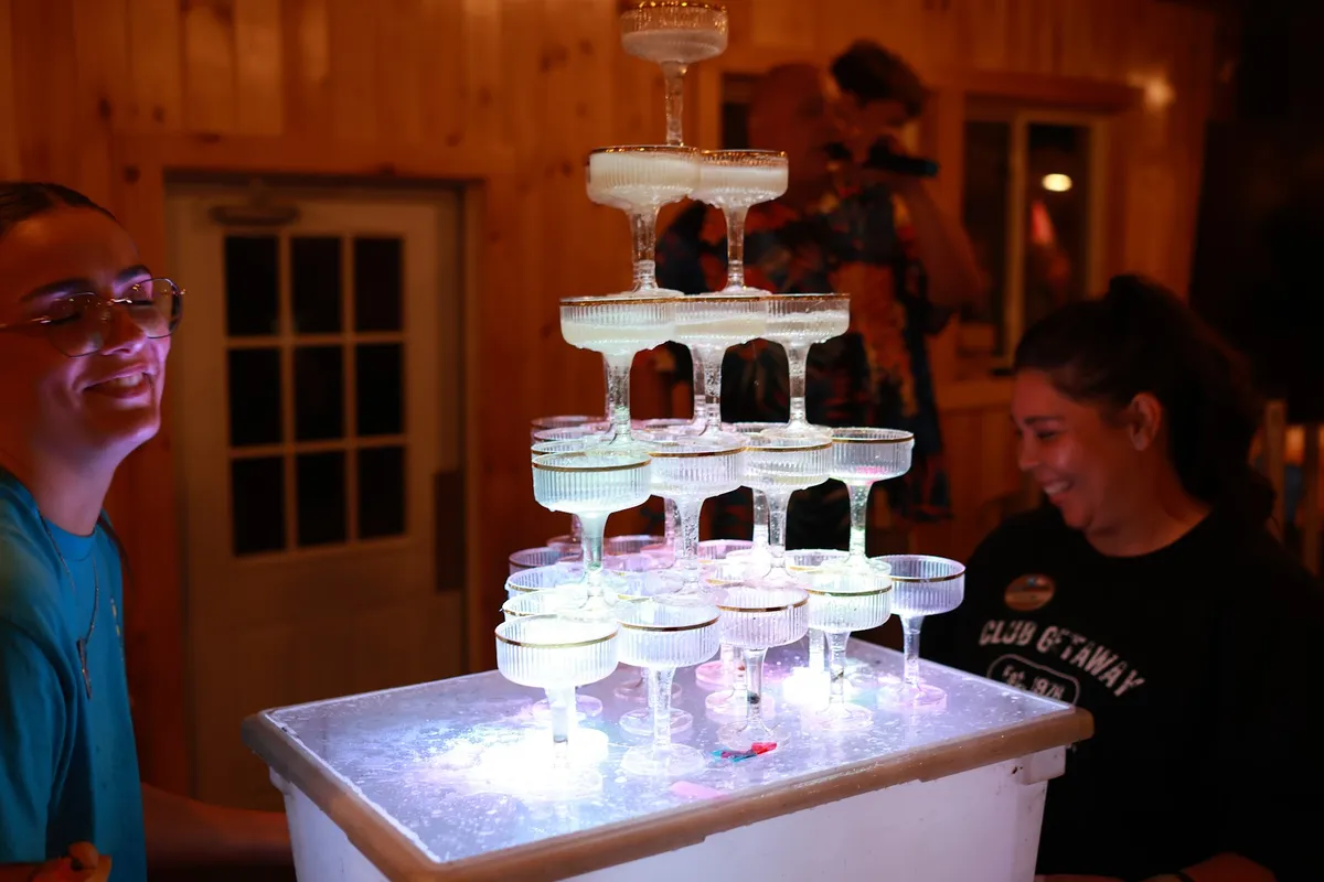 Champagne tower being poured at the reception